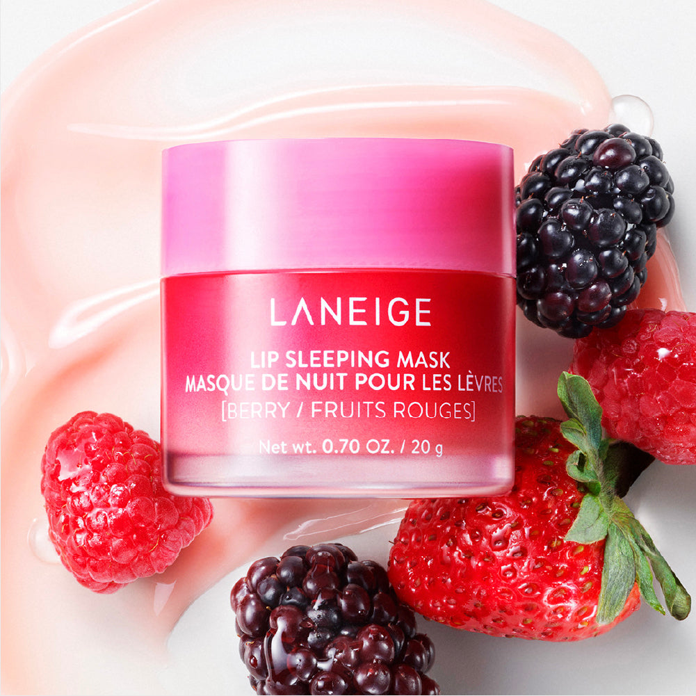 A small, pale pink jar of Laneige Lip Sleeping Mask Berry with a tiny applicator spoon, on a white ceramic dish.